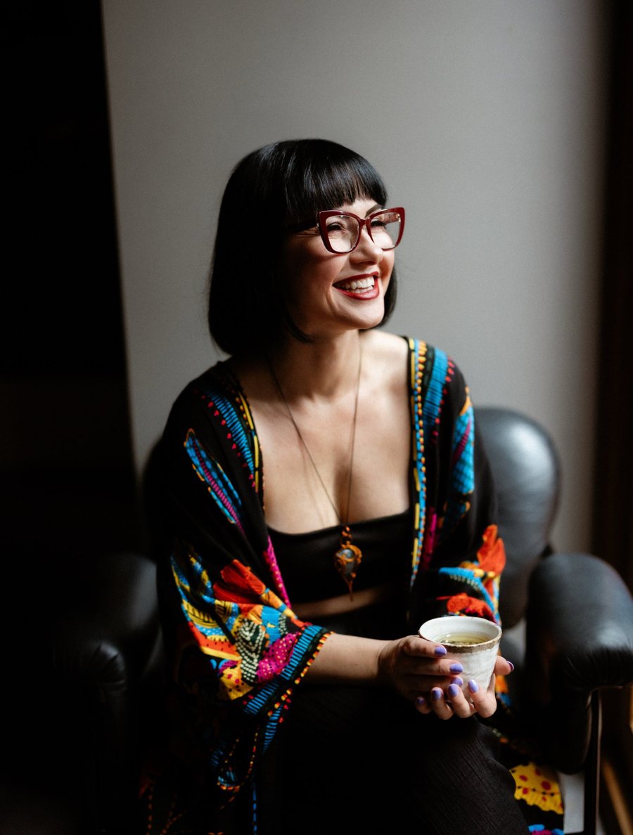 Kasia smiling with a cup of tea