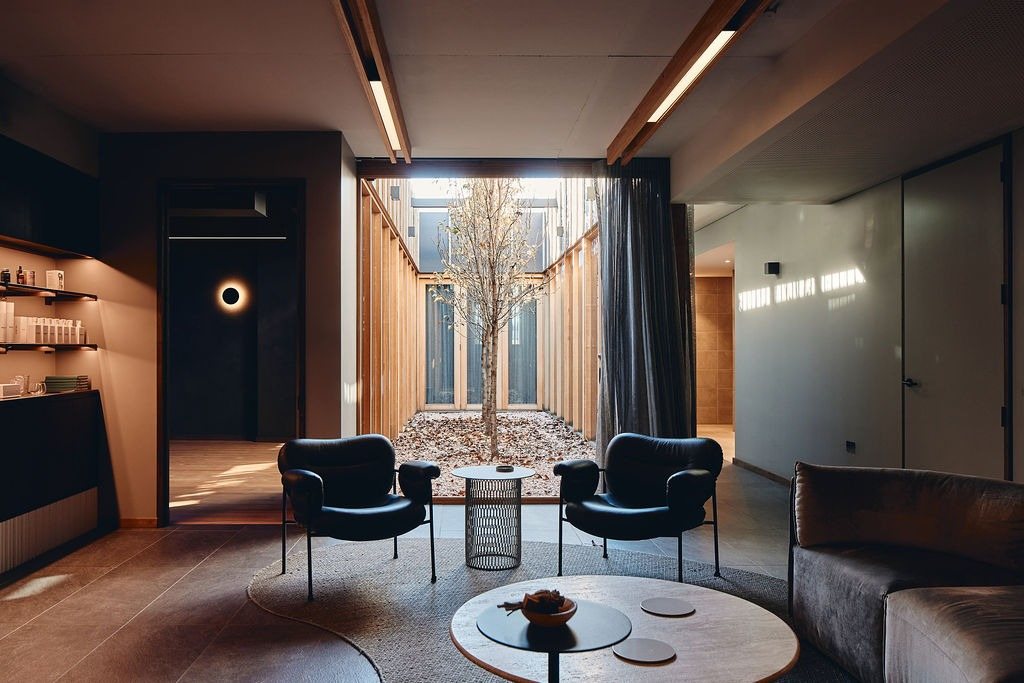The waiting lounge at Vitality House, with leather chairs facing the courtyard.