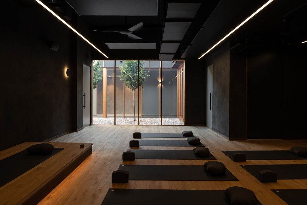 A dark, quiet movement room at Vitality House opening onto the courtyard.